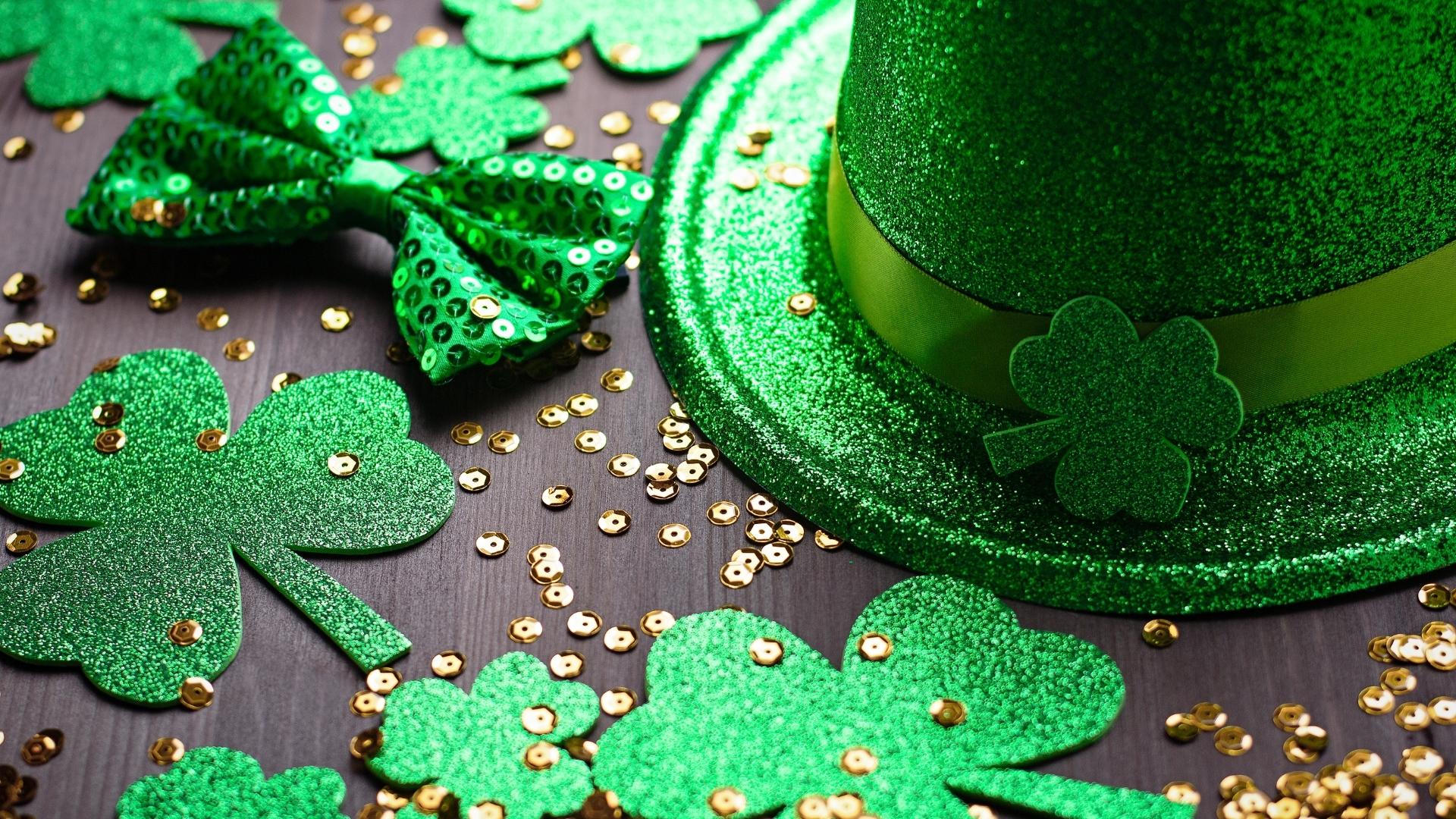 green glittery hat with glittery clovers and gold sequins