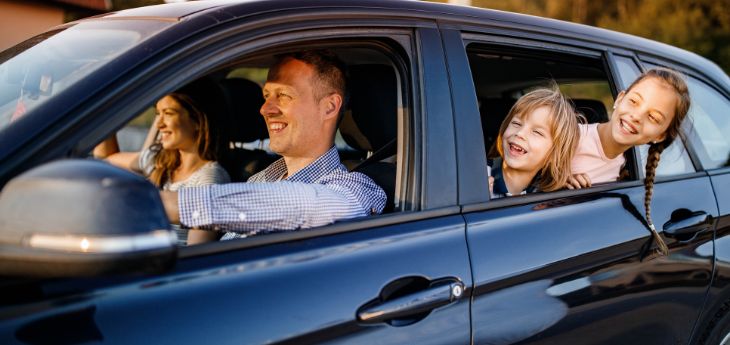 a man and two children in a car