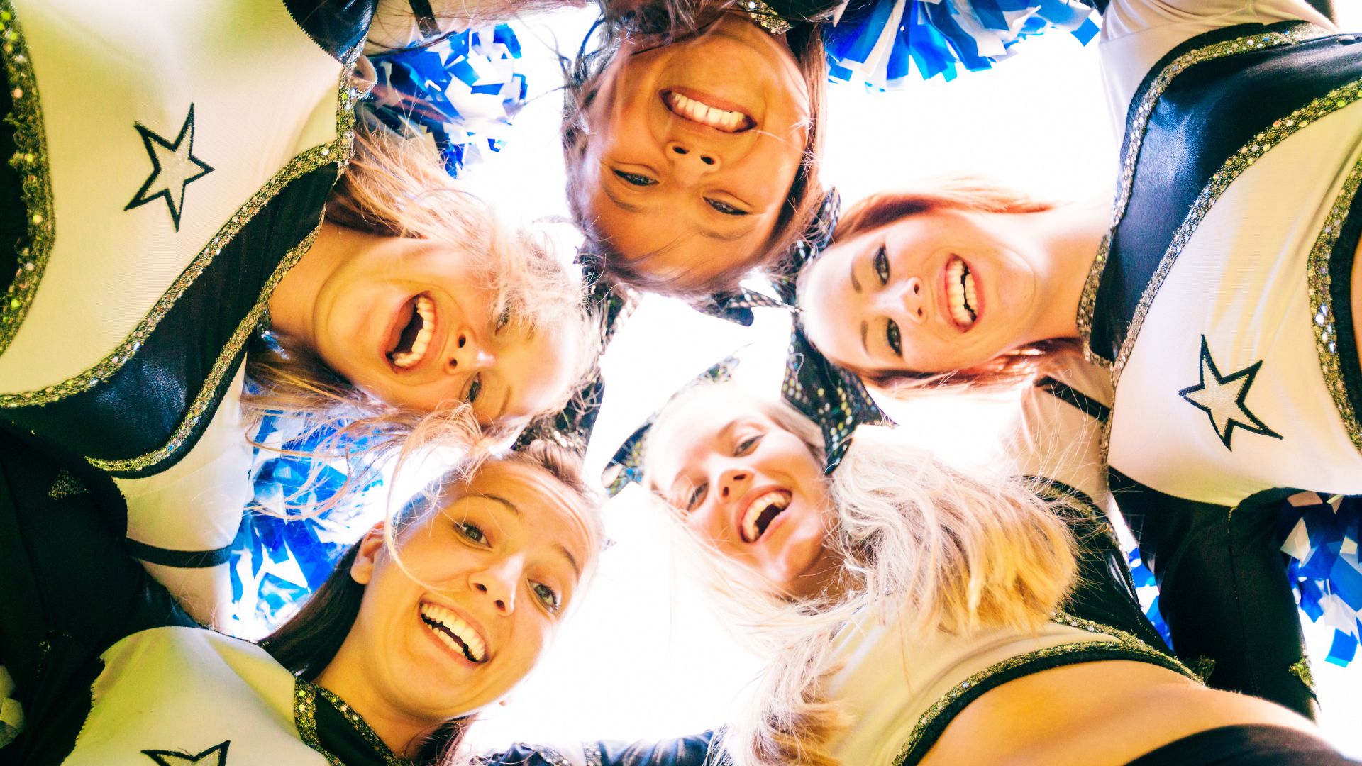 closeup of cheerleaders smiling 