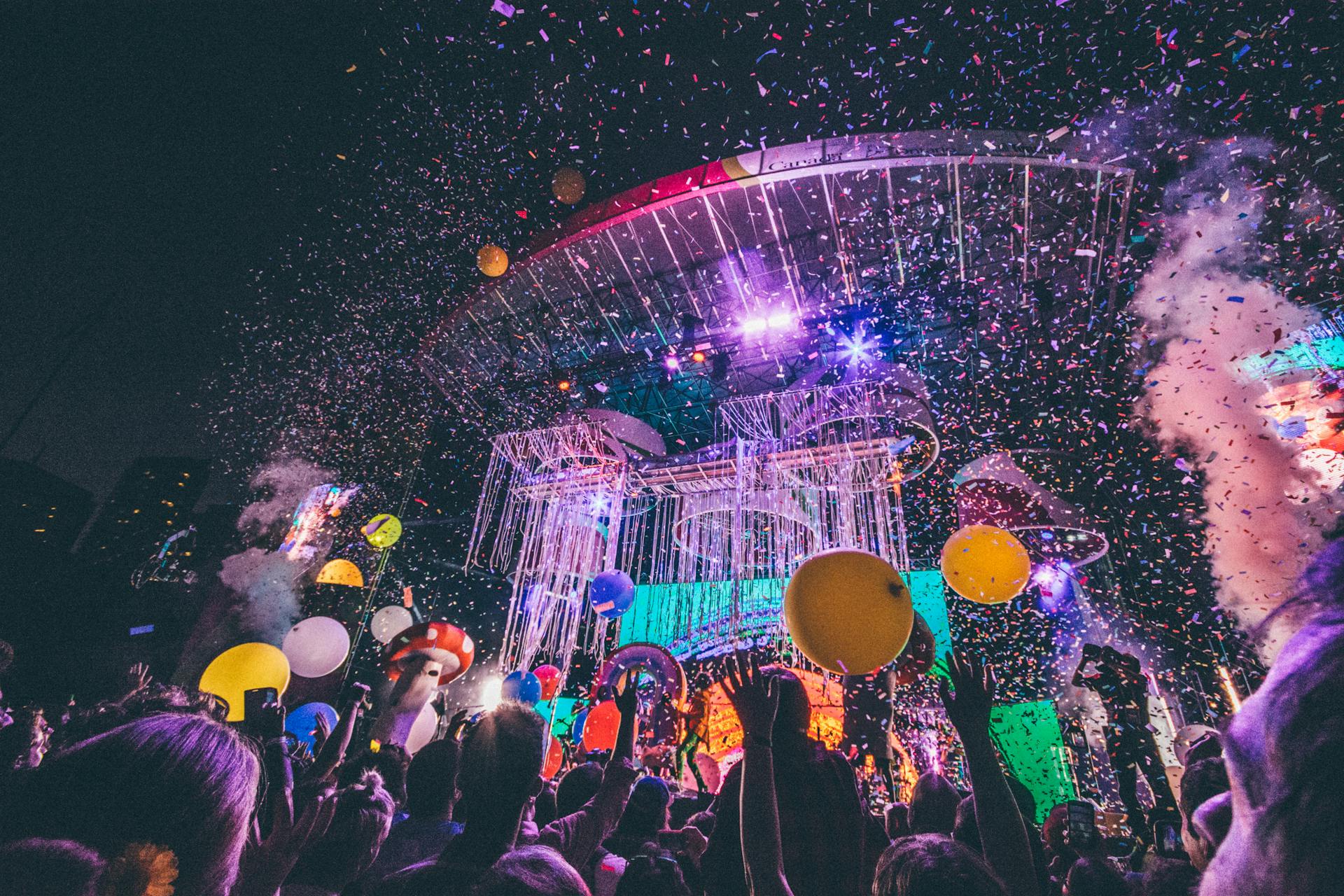 happy crowd at event looking up at confetti